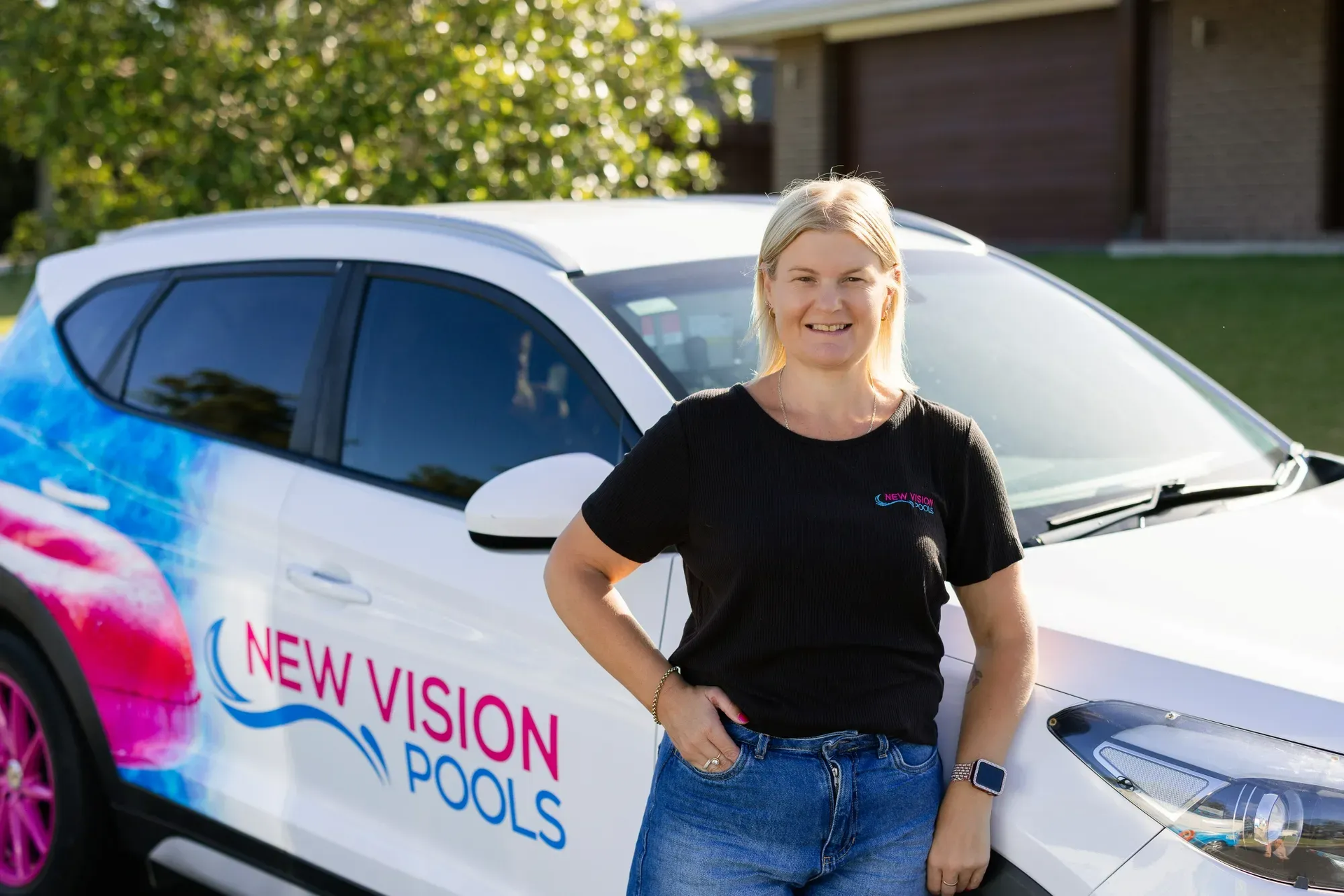 Woman Standing Beside White New Vision Pools SUV in A Suburban Driveway — New Vision Pools in Port Macquarie, NSW