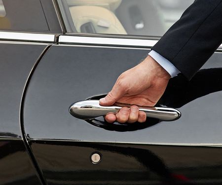 Up close to hand on the handle of a black car door to open | Master Tech Automotive Services