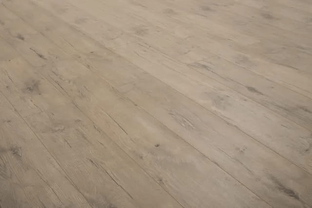 A close up of a wooden floor in a room.