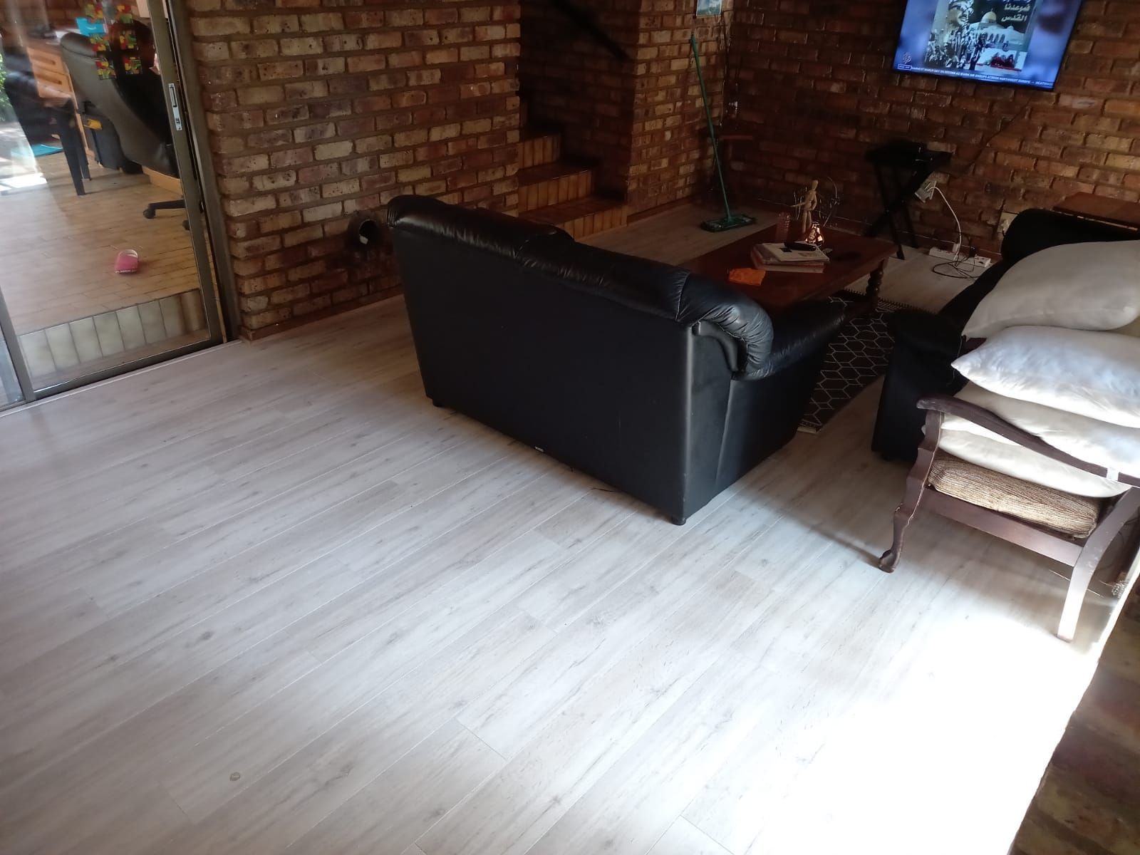 A living room with a couch a chair and a television