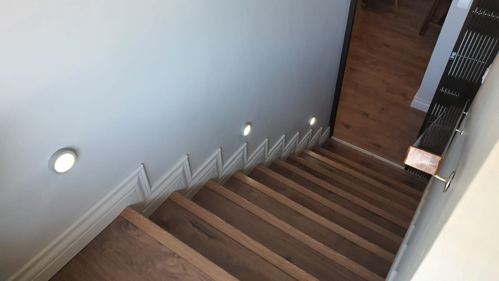 A set of wooden stairs leading up to the second floor of a house.