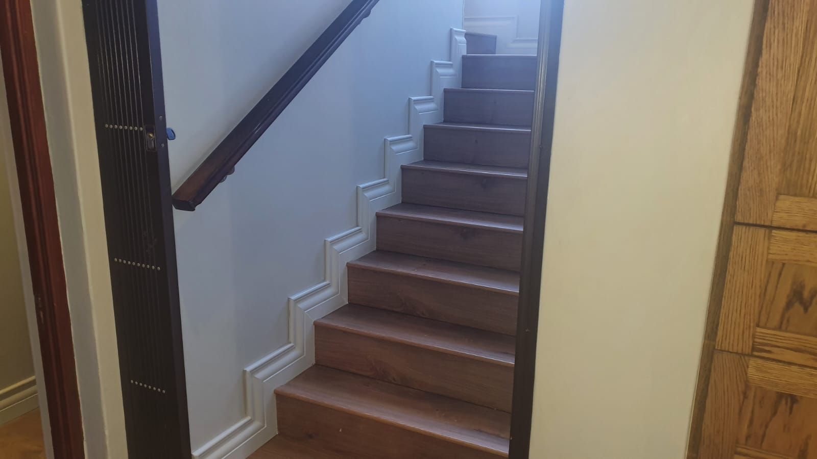 A set of wooden stairs leading up to the second floor of a house.
