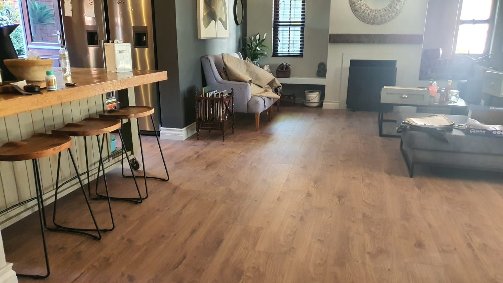 A living room with a wooden floor and a couch.