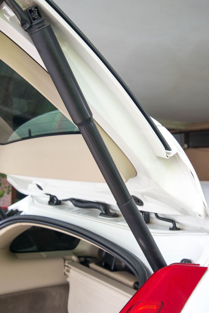 A White Car With the Trunk Open and a Red Tail Light — Strut Re-gas Mackay In Ooralea, QLD