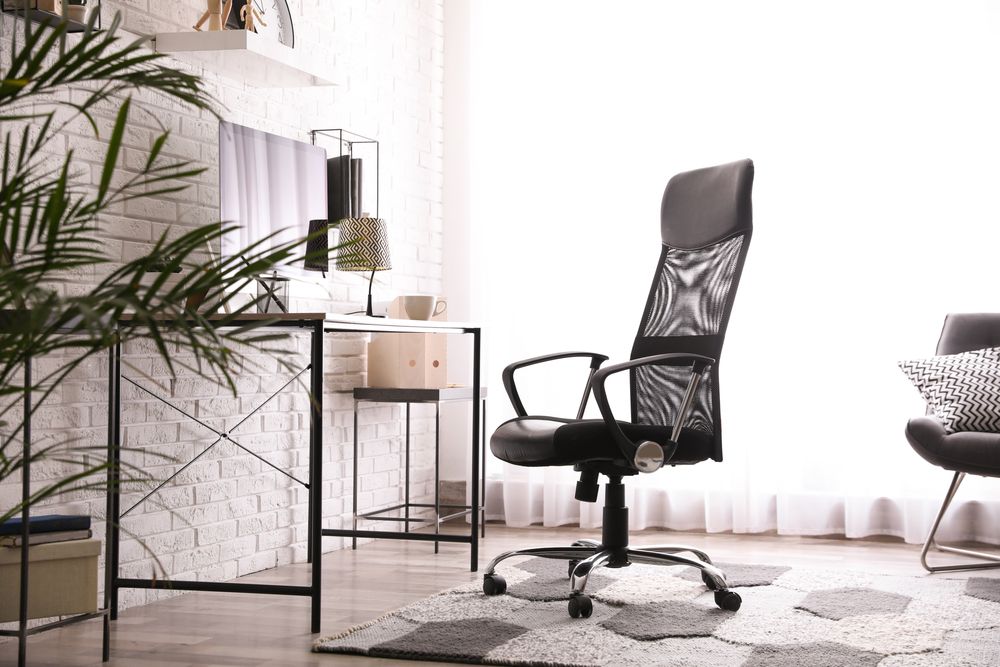 A Black Office Chair is Sitting in a Living Room Next to a Desk — Strut Re-gas Mackay In Ooralea, QLD
