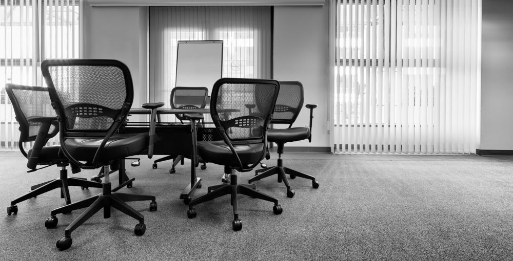 A Black and White Photo of a Conference Room With a Table and Chairs — Strut Re-gas Mackay In Sarina, QLD