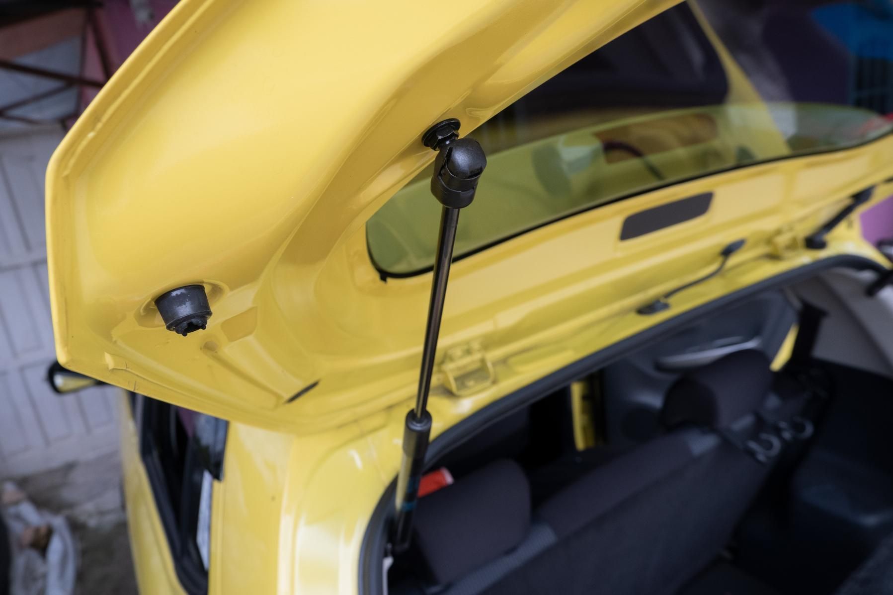 The Back of a Yellow Car With the Trunk Open — Strut Re-gas Mackay In Ooralea, QLD