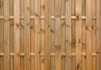 A close up of a wooden fence made of wooden planks.