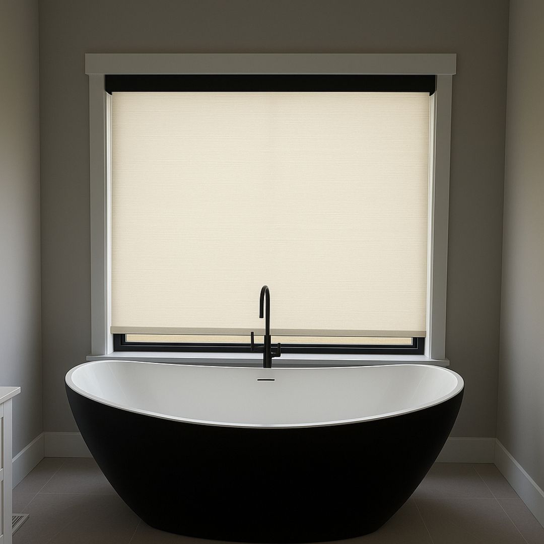 Modern bathroom with a black freestanding tub beneath a window with a beige shade