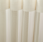 Sheer white curtains with soft vertical folds hanging in front of a window