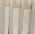 Close-up of cream-colored pleated fabric panels