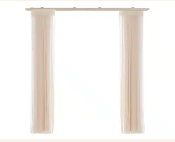 Two cream-colored sheer curtain panels hanging from a rod on a white background