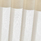 Close-up of sheer white curtains with a beige top border, softly lit by daylight.