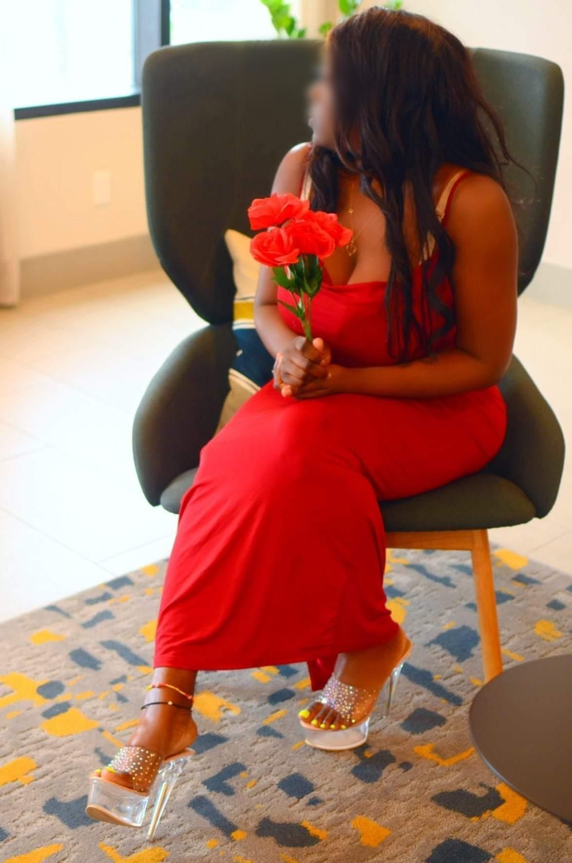 Luxury companion portrait in red dress, discreet private experience in NYC