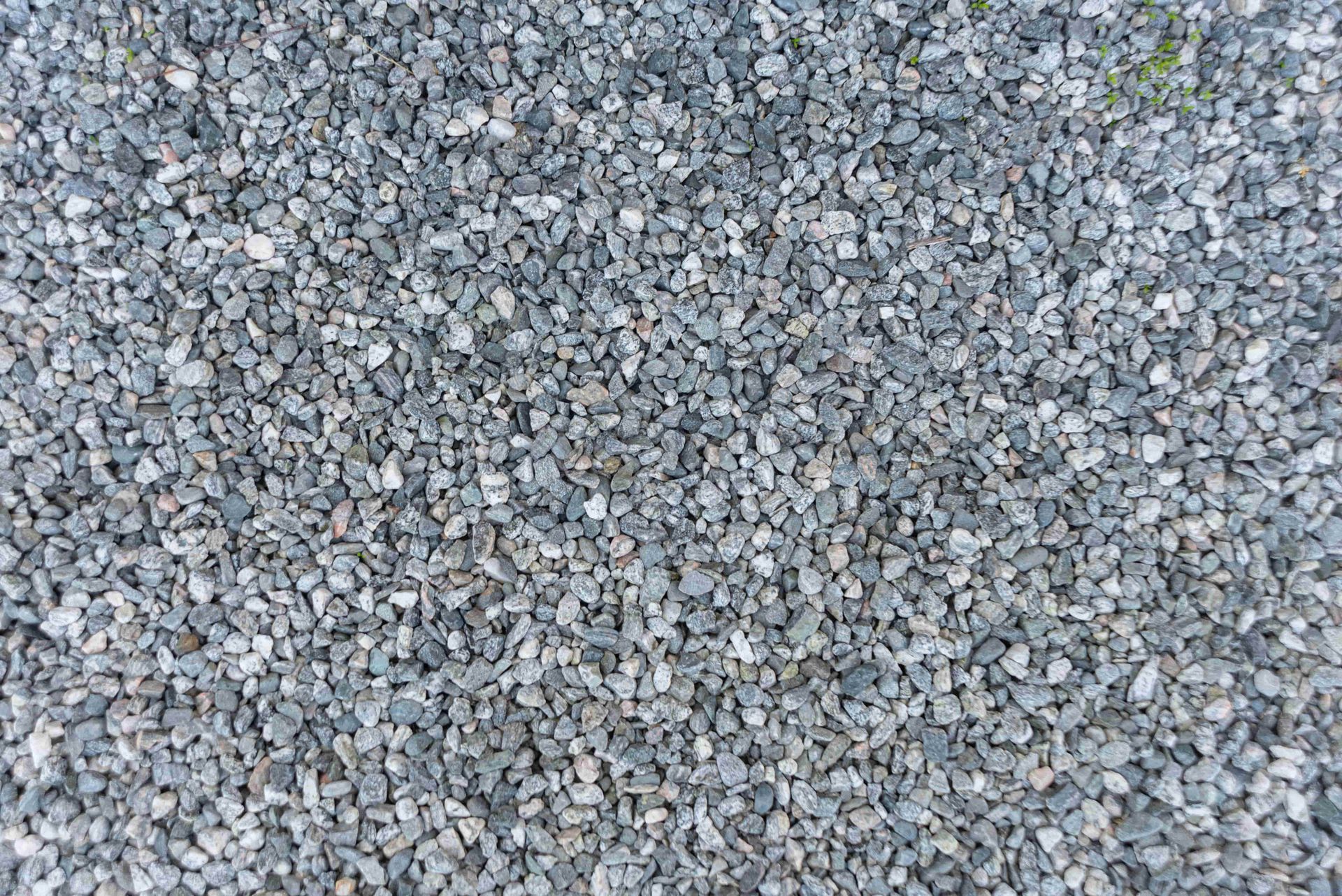 Close-up of gray gravel stones with a rough, textured surface