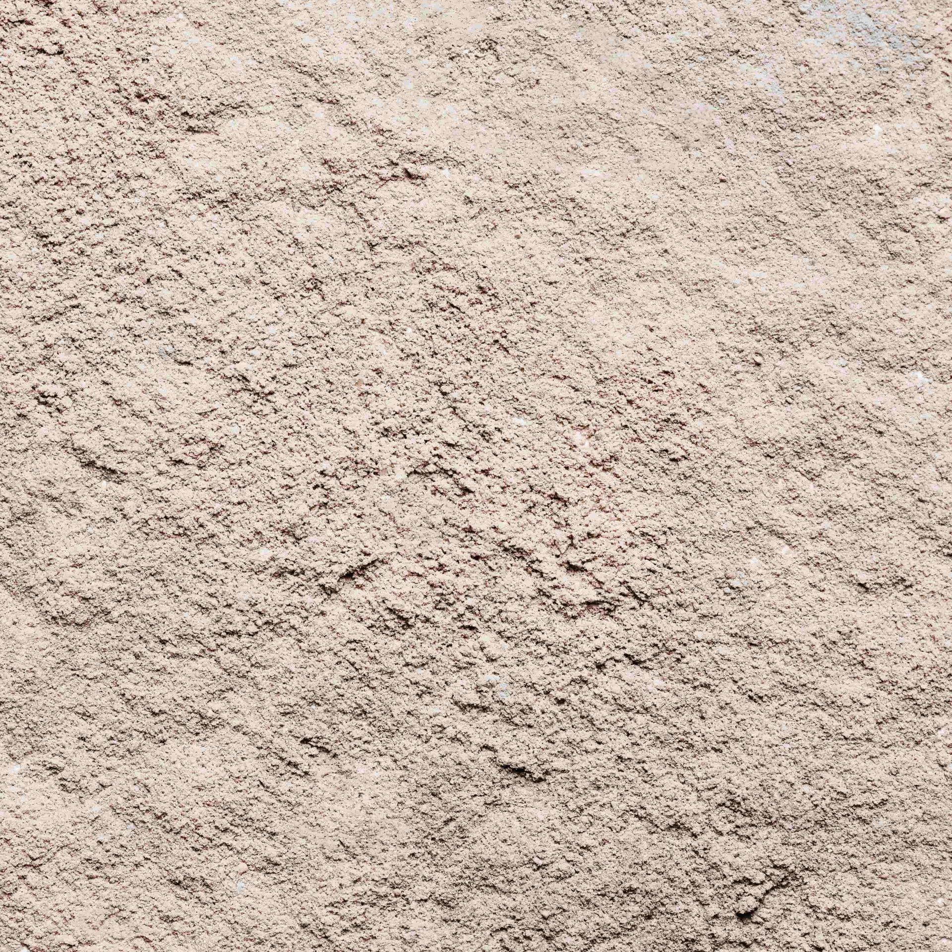 Close-up of a light beige textured surface with a rough, grainy pattern