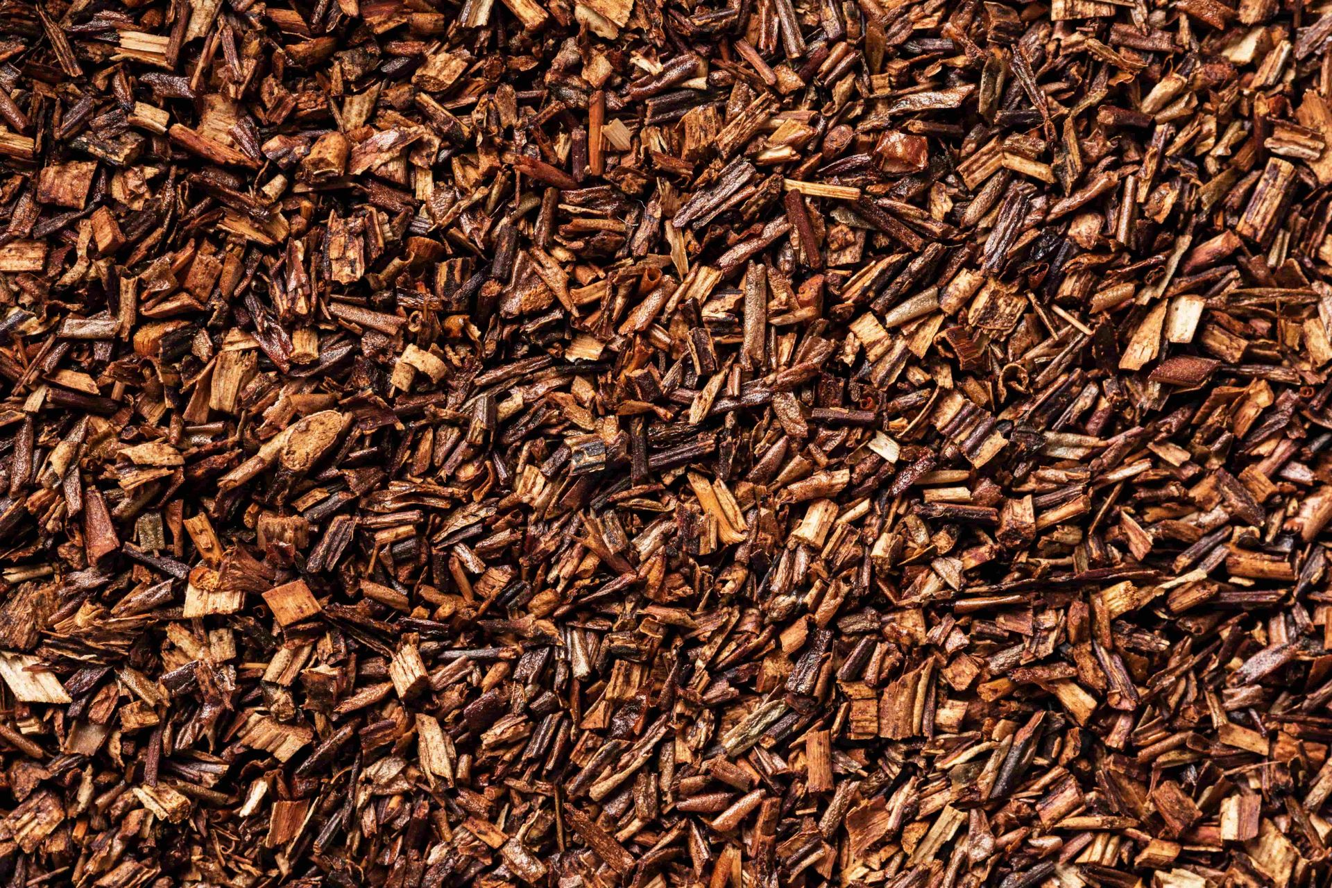 Close-up of brown wood chips or bark mulch covering the ground