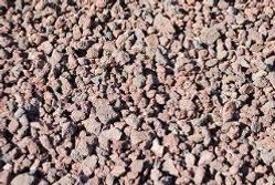 Close-up of small pinkish-brown gravel stones covering the ground