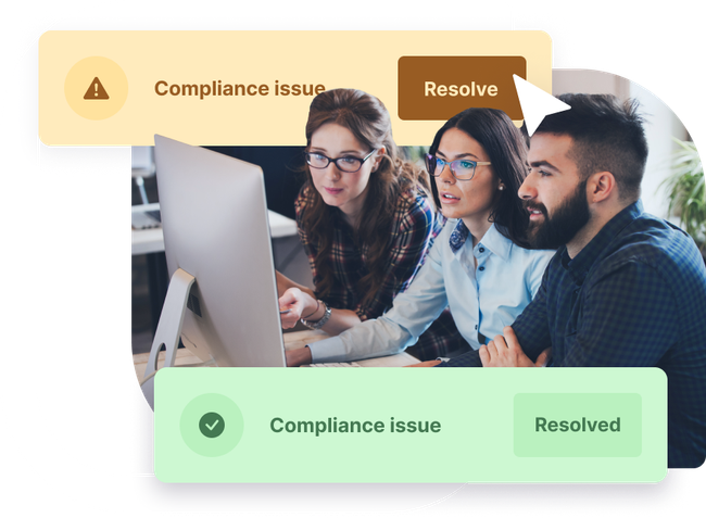 A team working together at a computer to detect and resolve compliance issues.