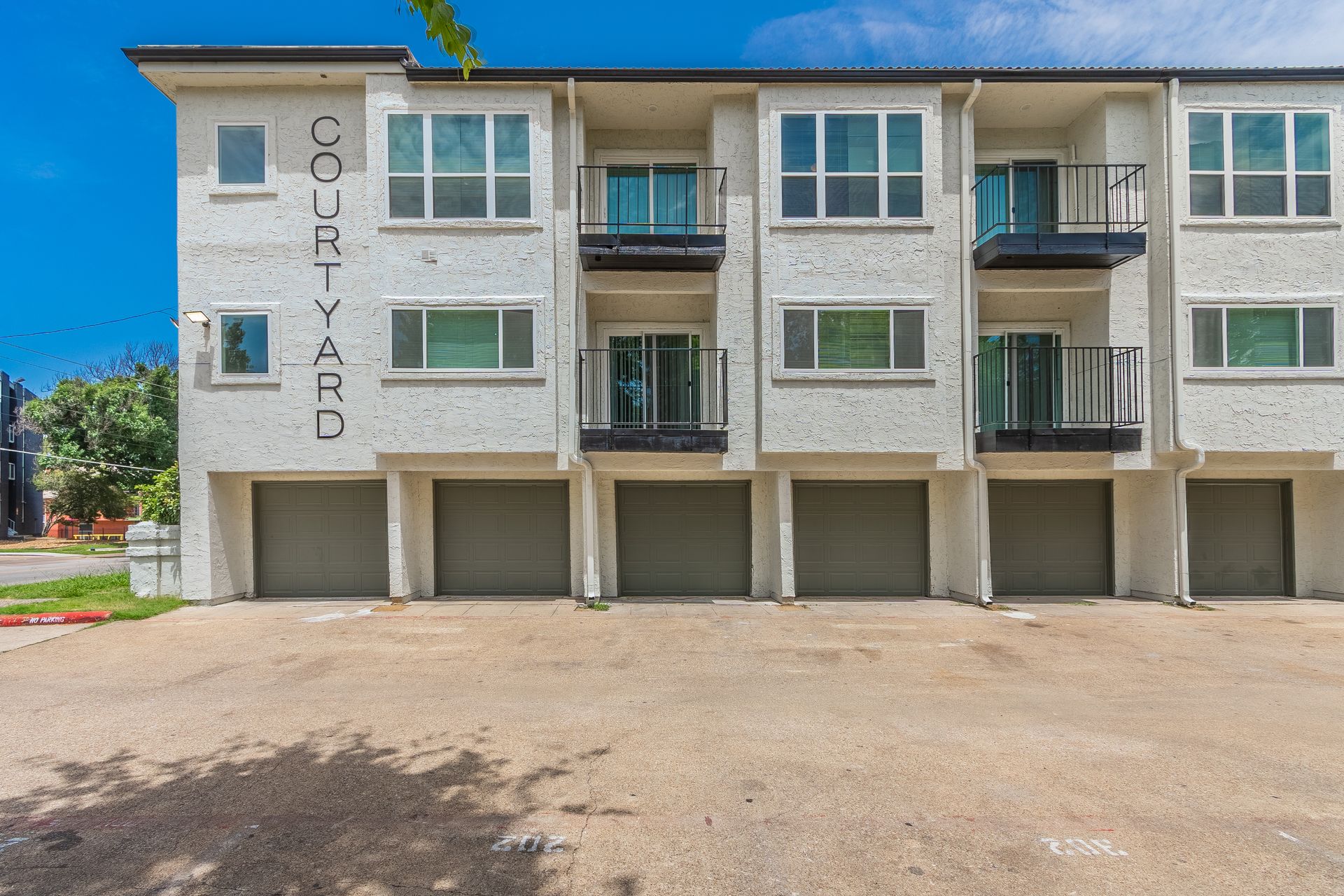 Condos with garage parking, three stories tall, labeled 
