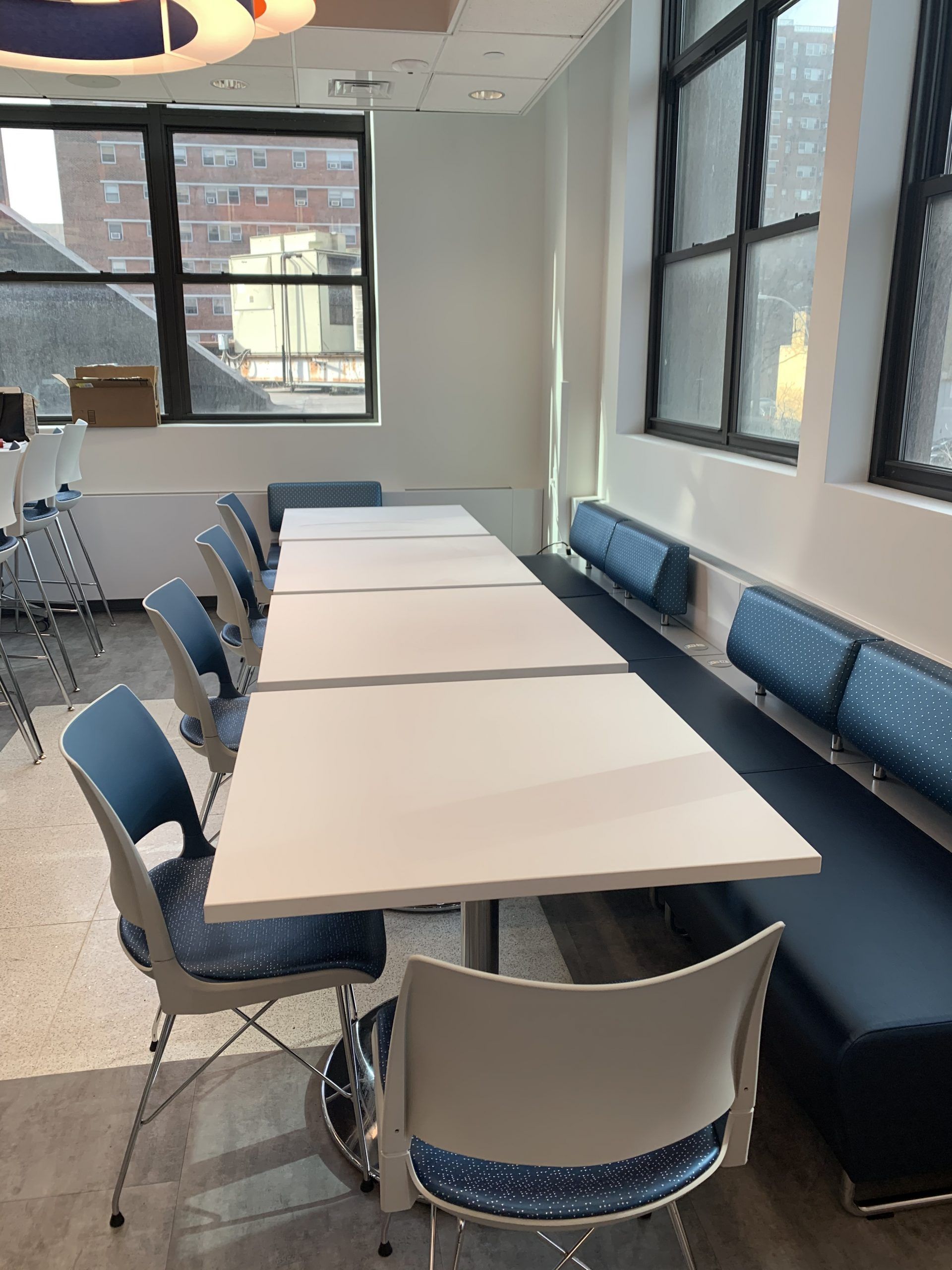 A long table in a room with blue chairs