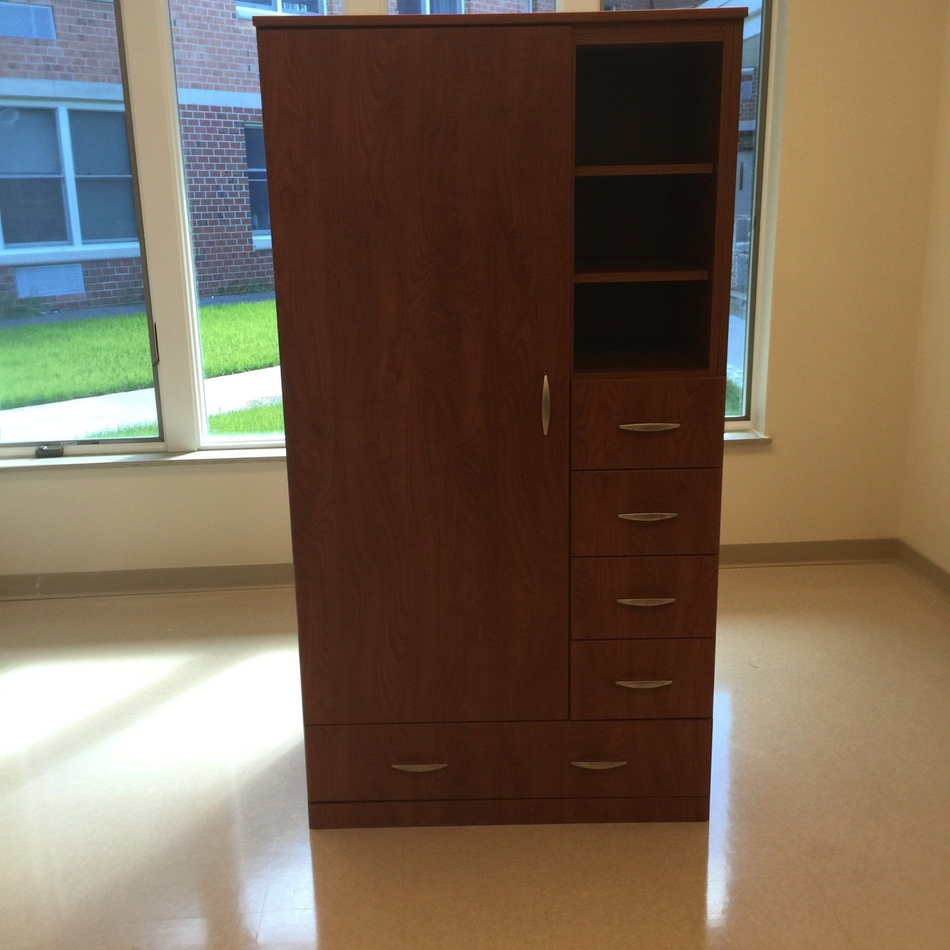 A wardrobe with drawers and shelves in a room with a window