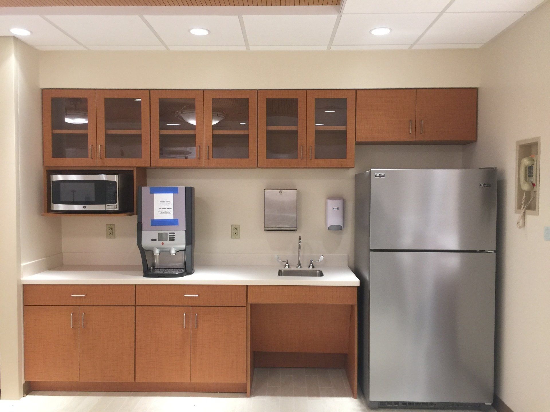 A kitchen with stainless steel appliances and wooden cabinets