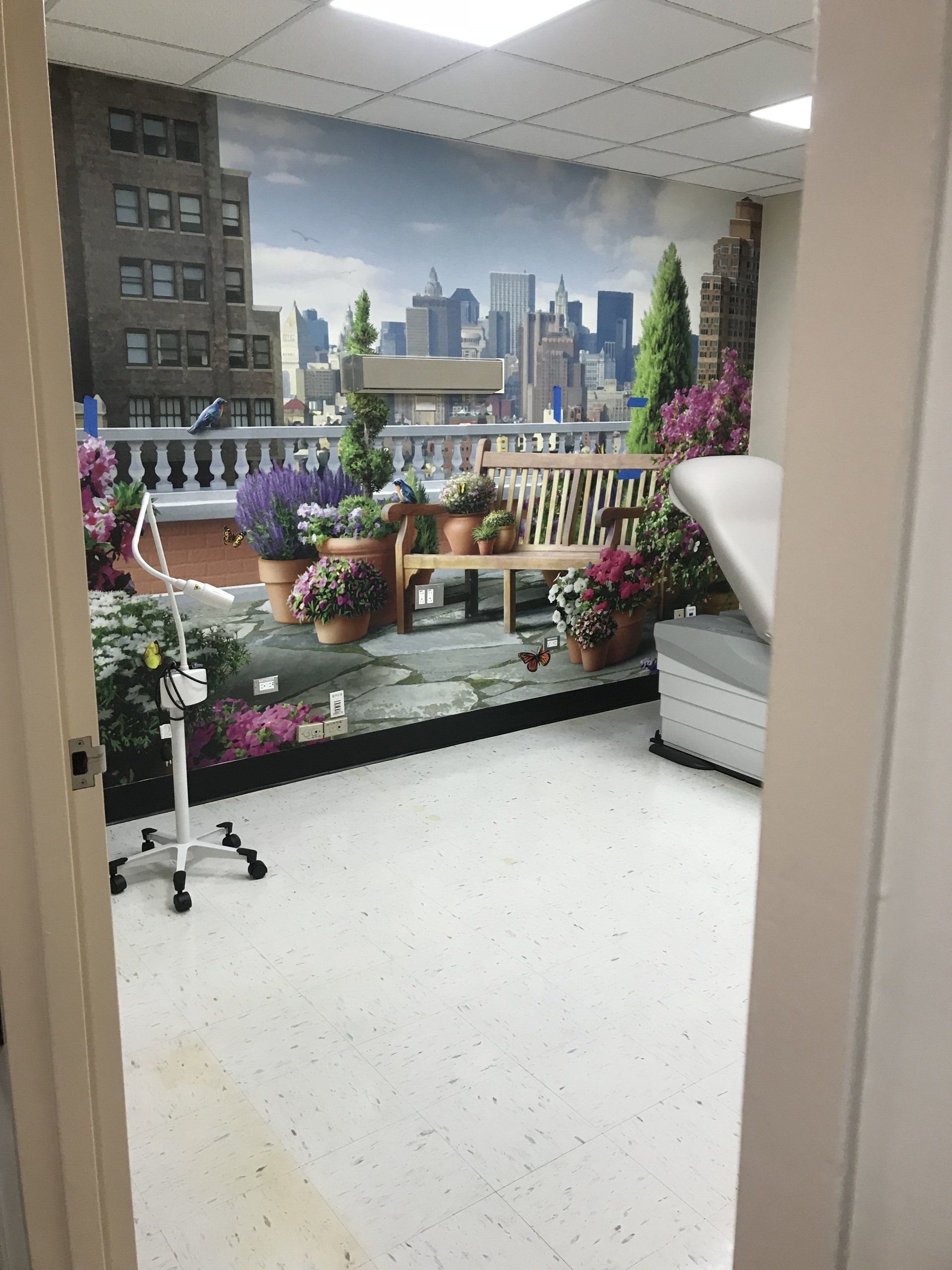 A room with a picture of a city on the wall