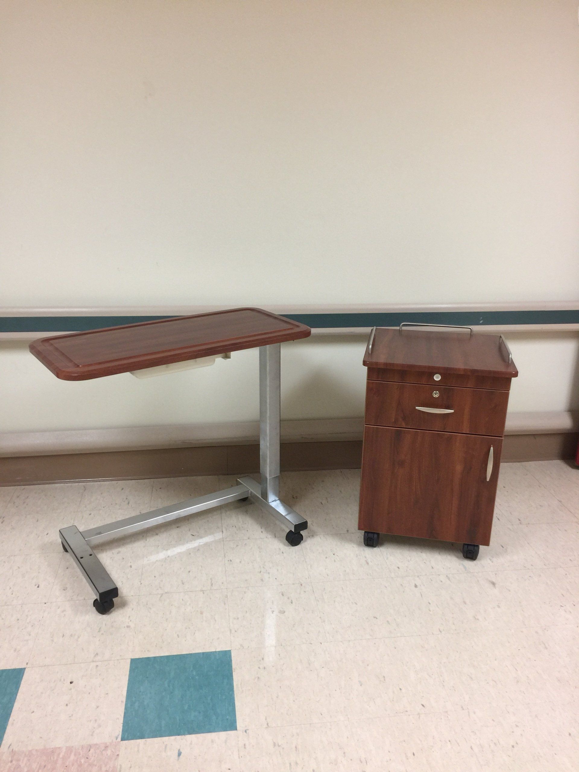 A hospital room with a table and a nightstand