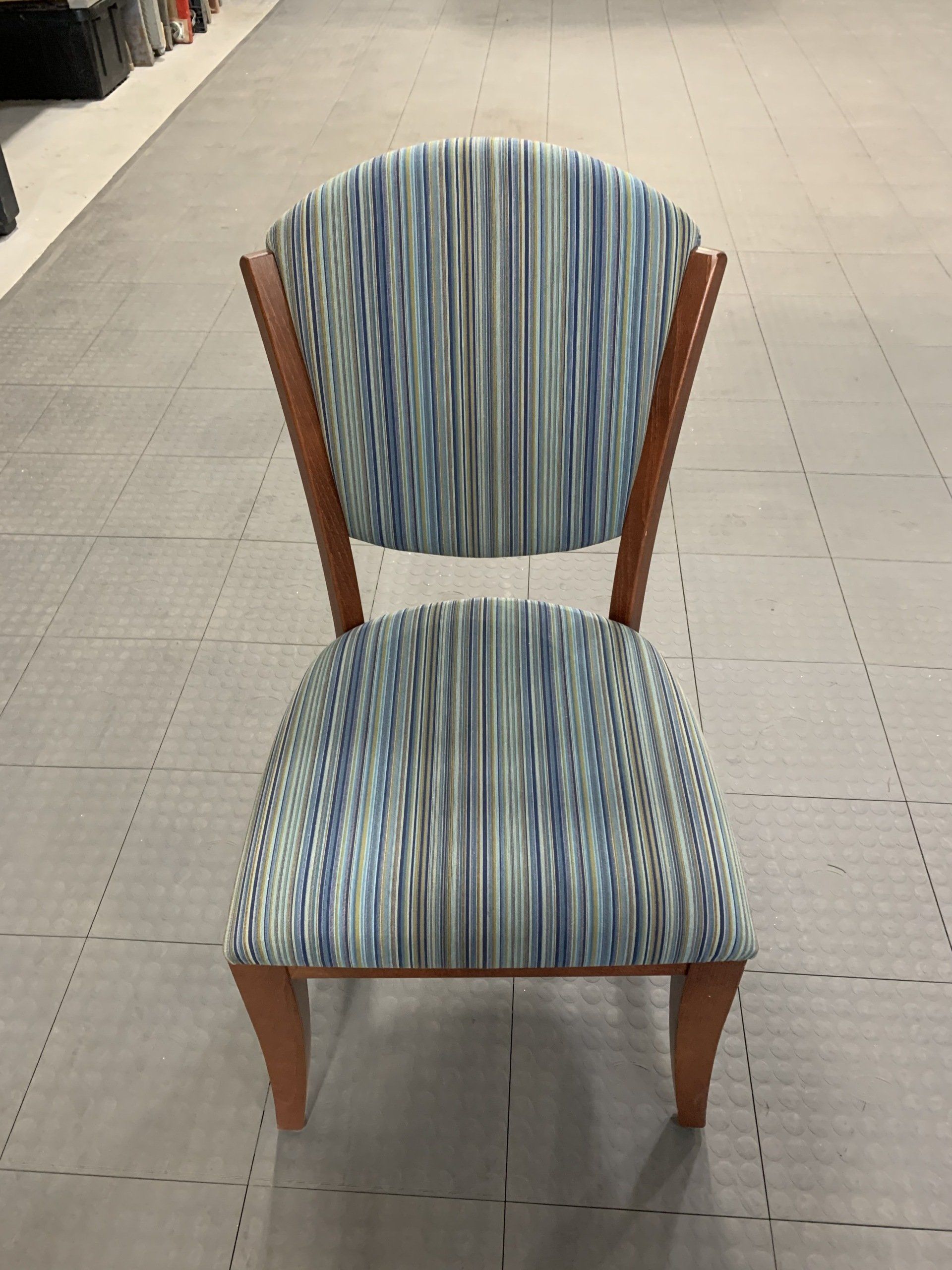 A blue and white striped chair with wooden legs