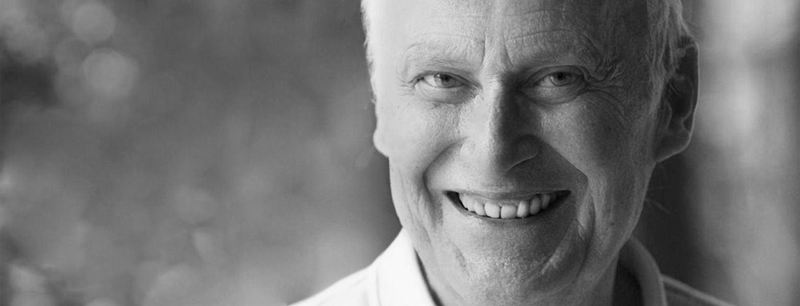 Una fotografía en blanco y negro de un hombre mayor sonriendo.