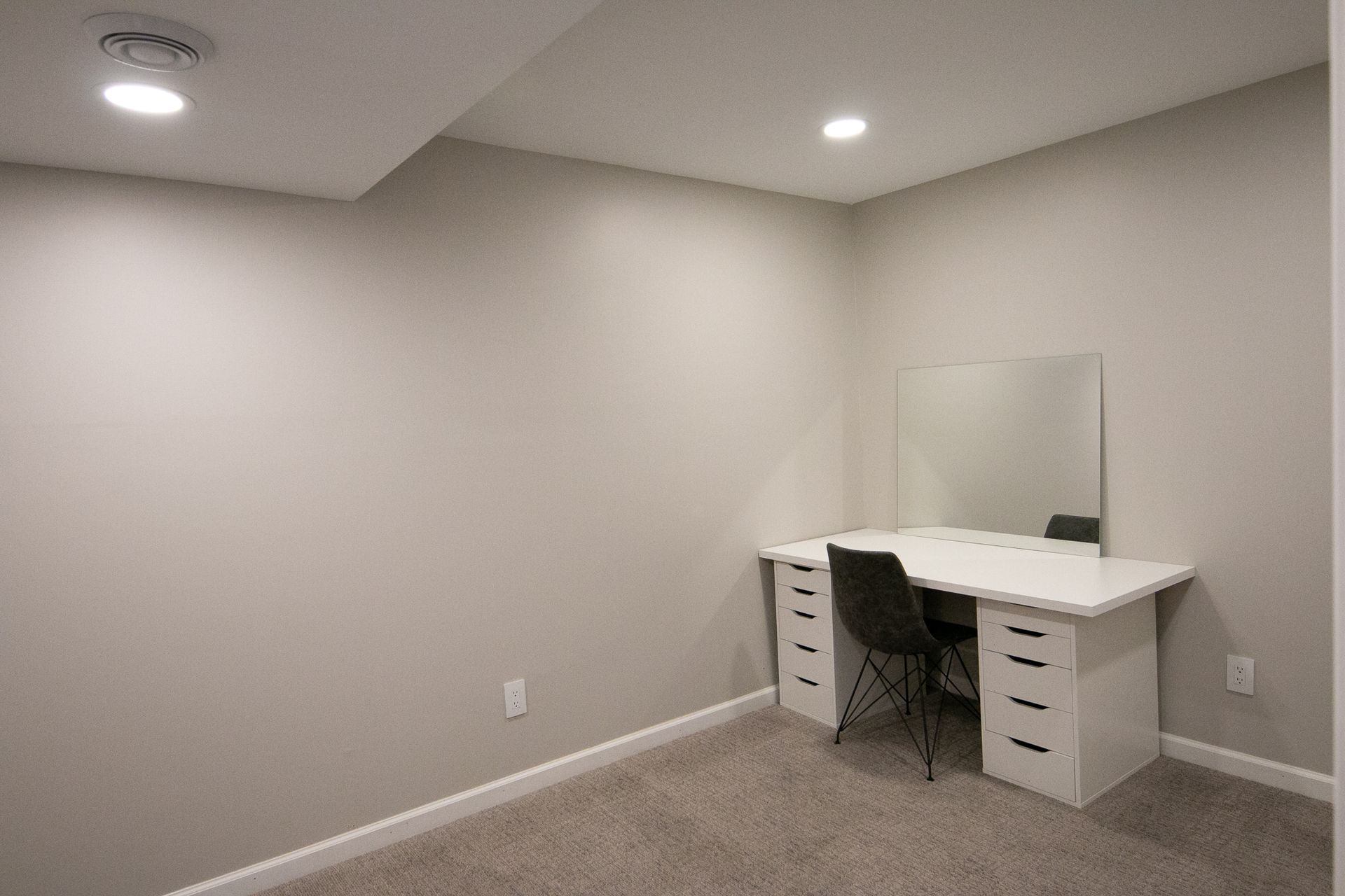 There is a desk and a chair in the room.