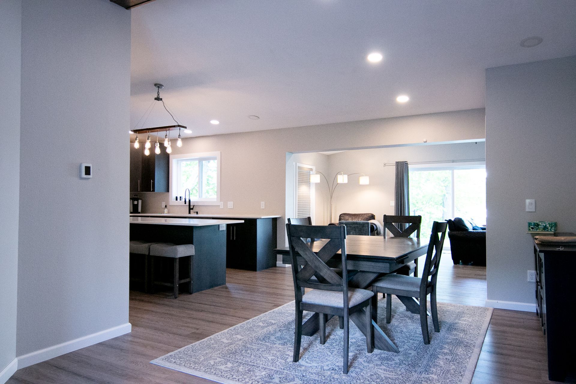 There is a dining table and chairs in the middle of the room.