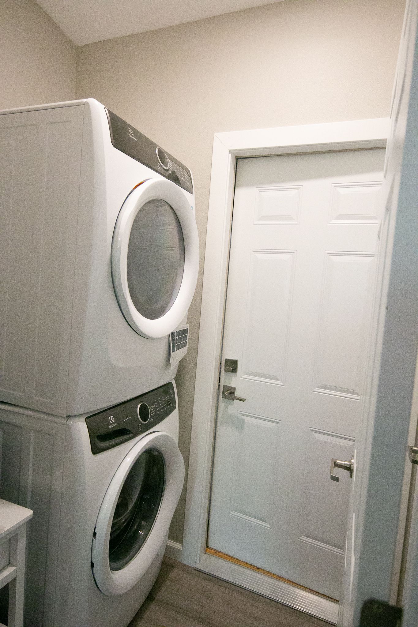 A washer and dryer are stacked on top of each other in a laundry room.