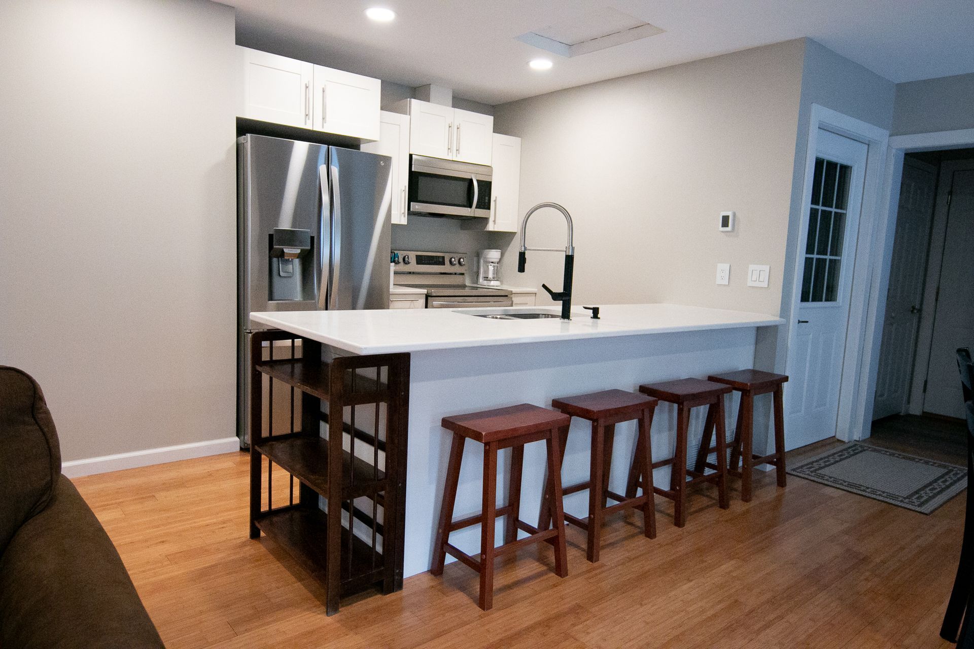 A kitchen with a large island and stools