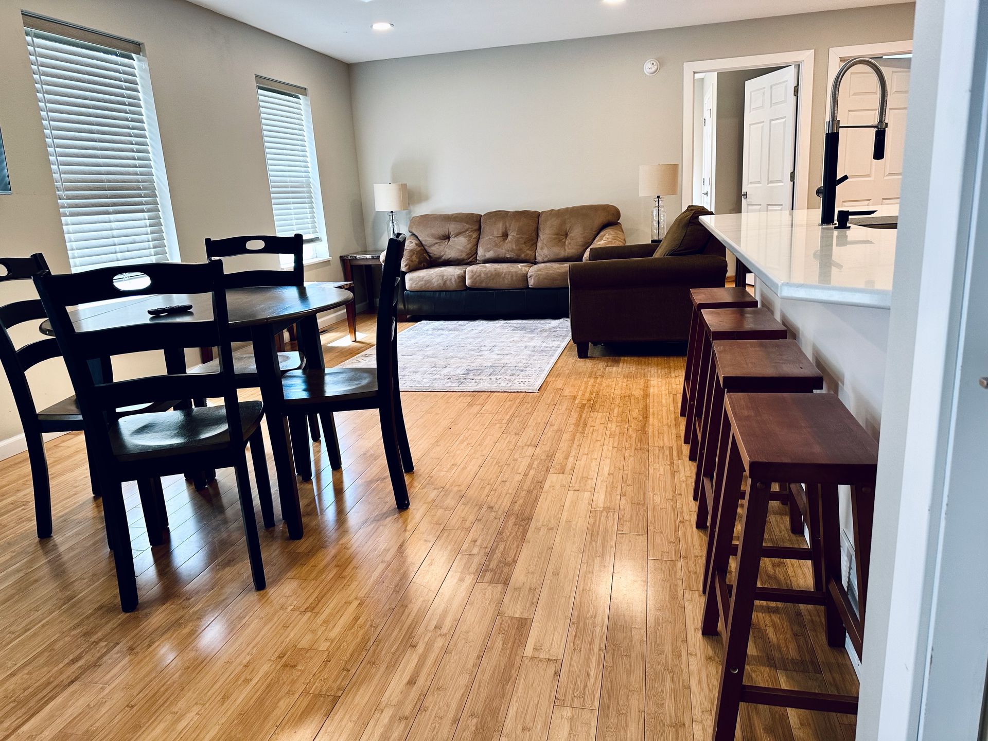 A living room with a couch , table and chairs