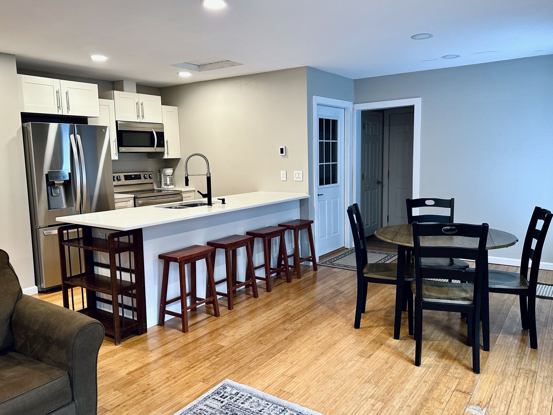 A kitchen and dining room in a house with a table and chairs.