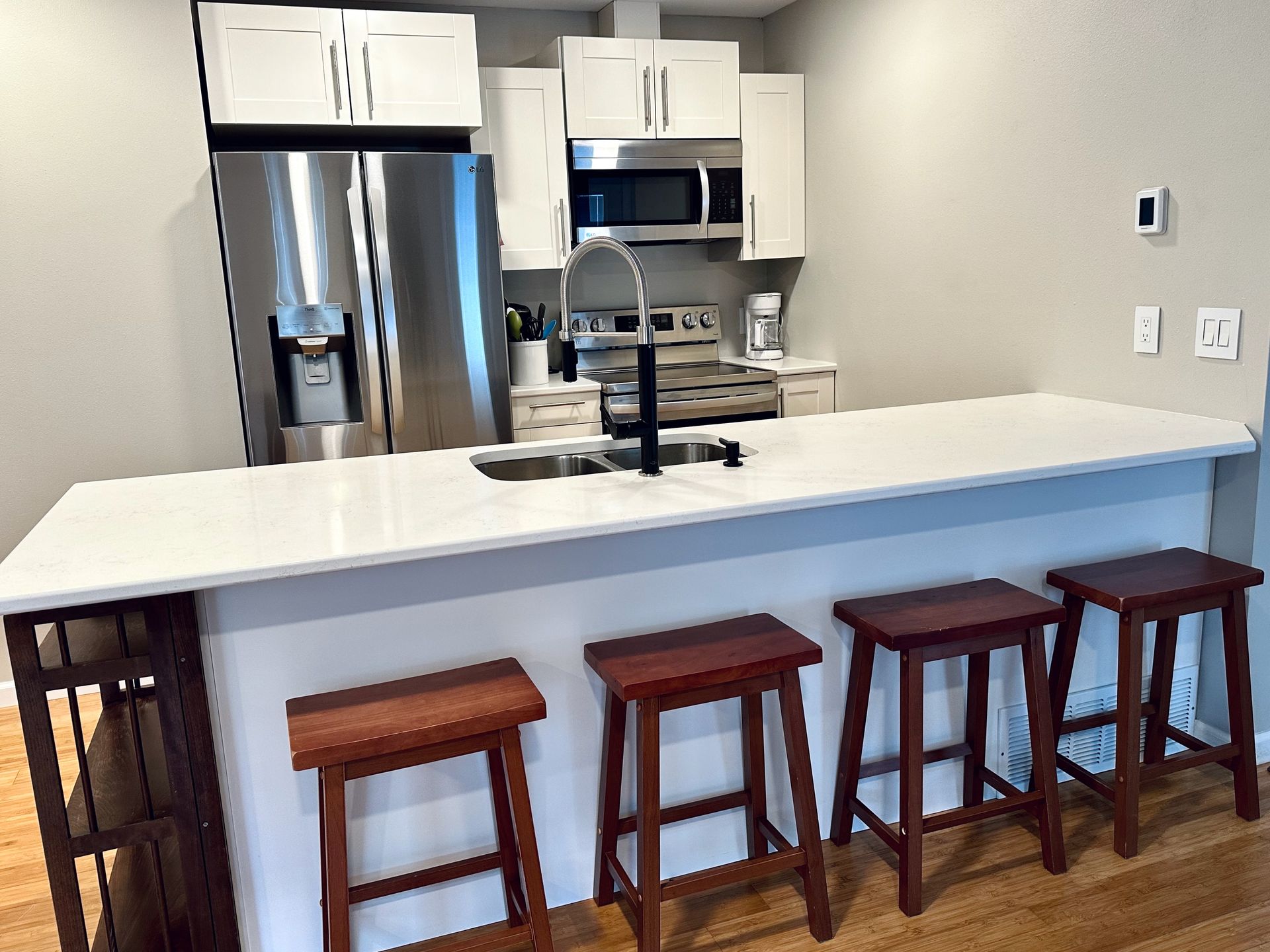 A kitchen with a large island and stools