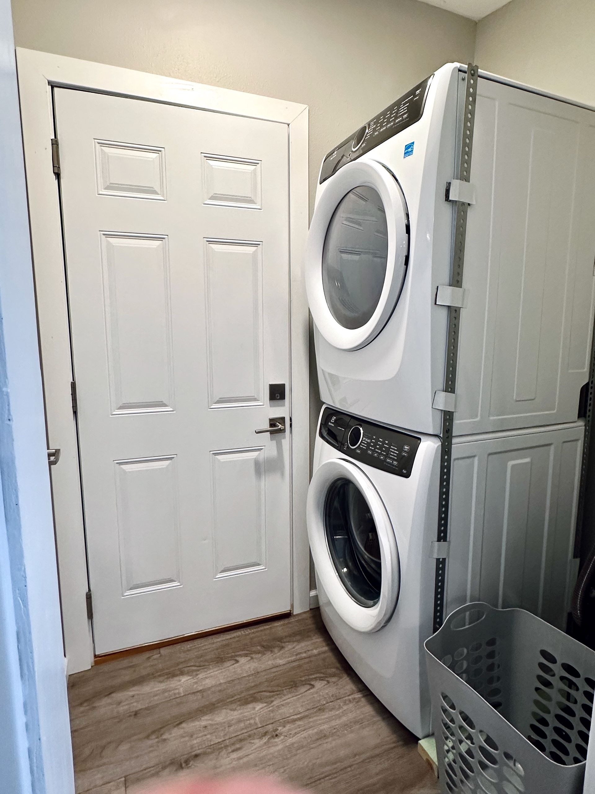 A laundry room with a washer and dryer stacked on top of each other.