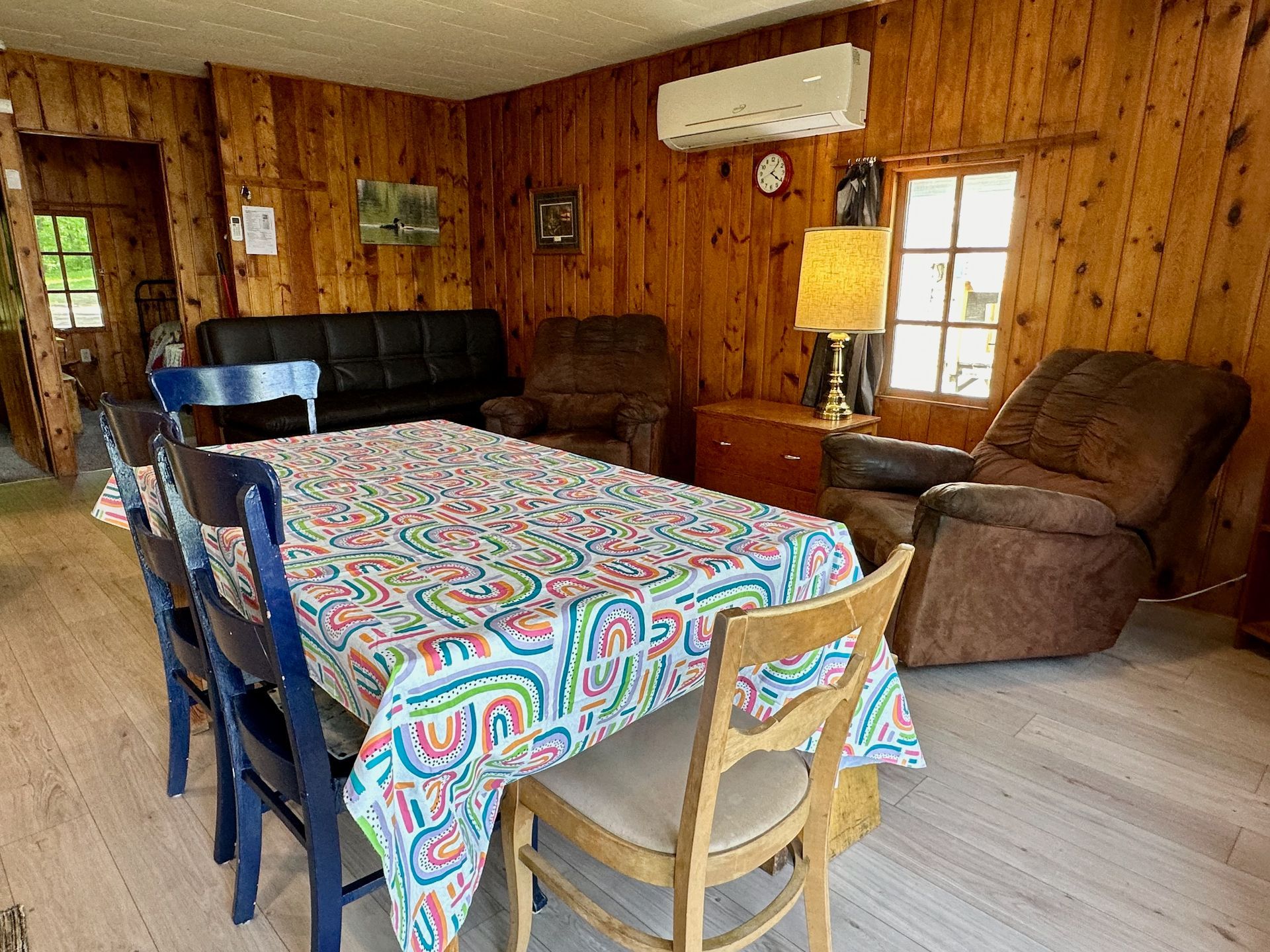 A living room with a table , chairs , and a couch.