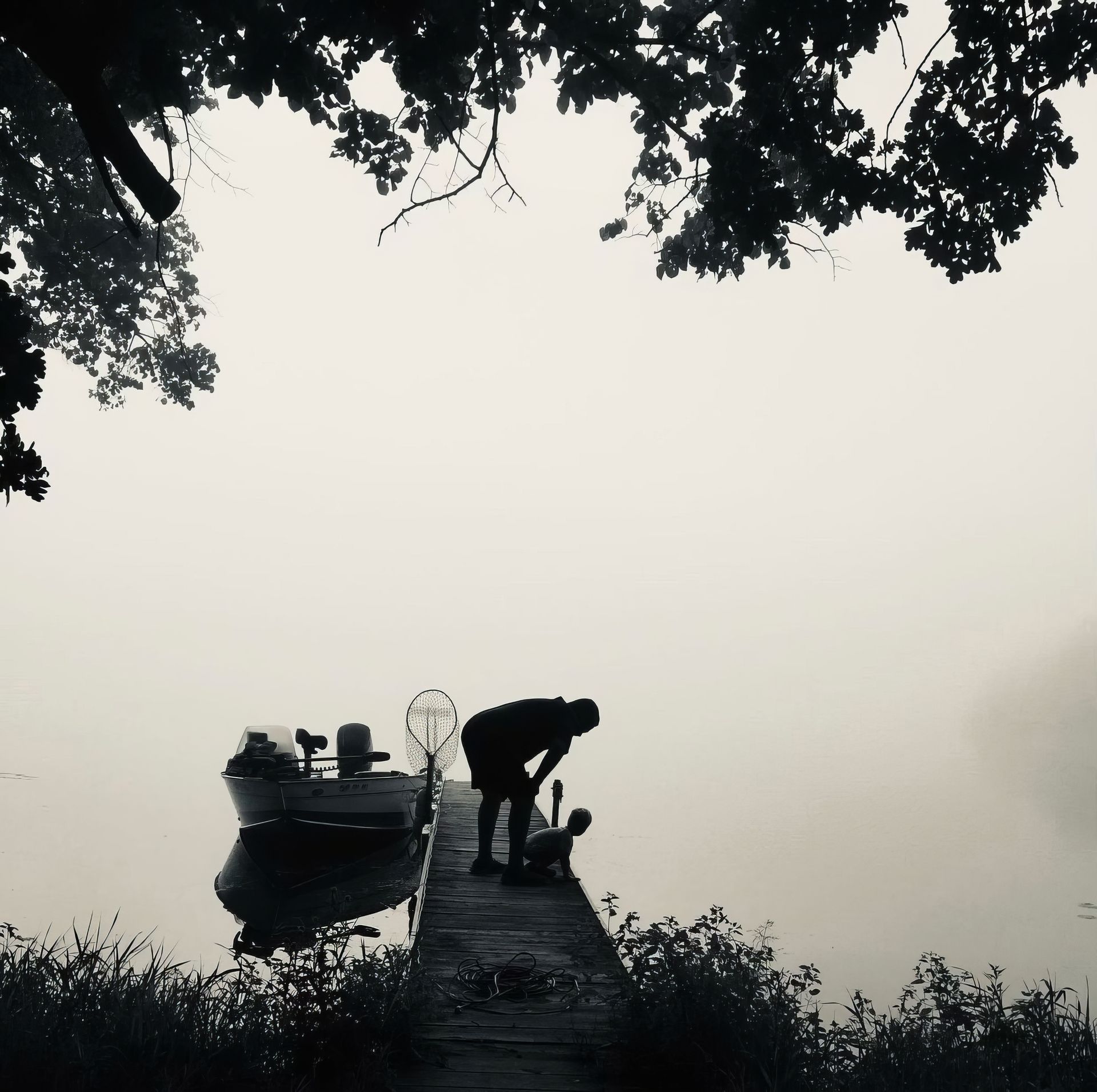 A man standing on a dock next to a boat