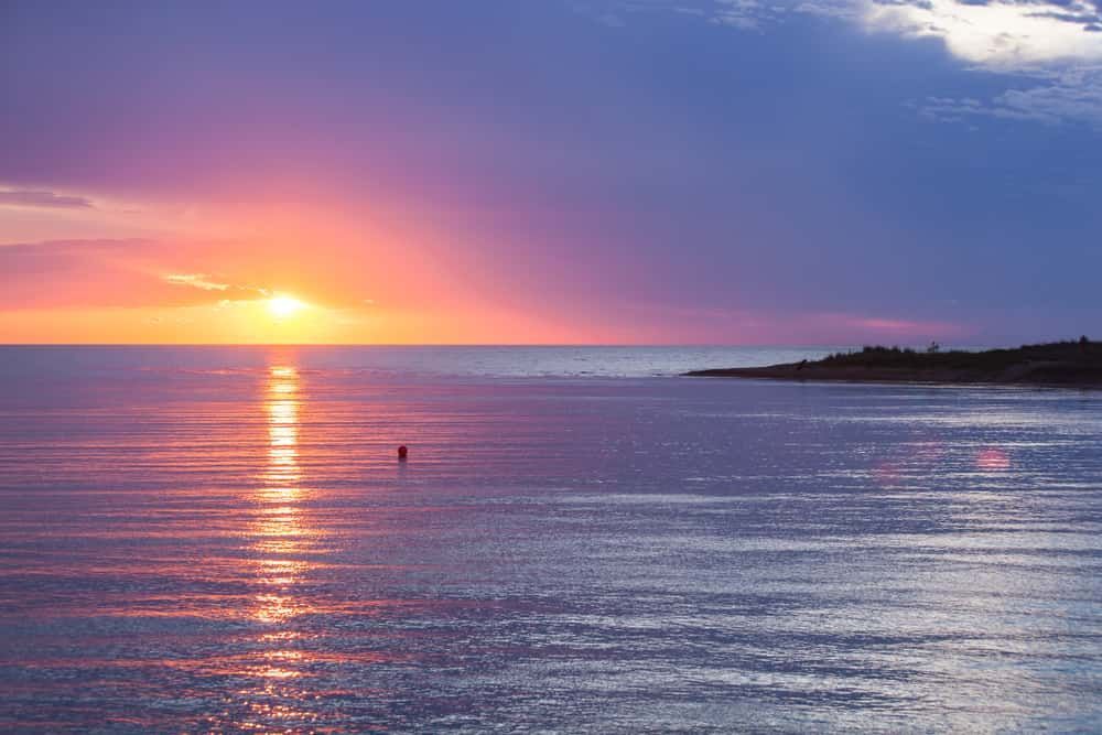 A Sunset Over A Body Of Water With A Buoy In The Water — Allpower Electrical Wholesalers Pty Ltd In Weipa, QLD