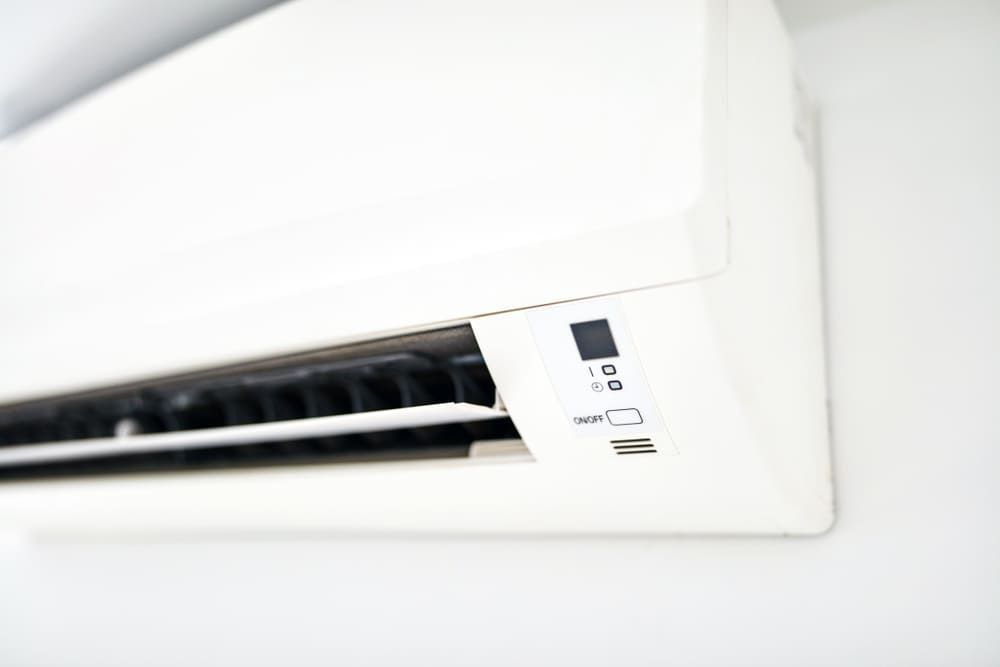 A White Air Conditioner Is Hanging On A White Wall — Allpower Electrical Wholesalers Pty Ltd In Cairns, QLD