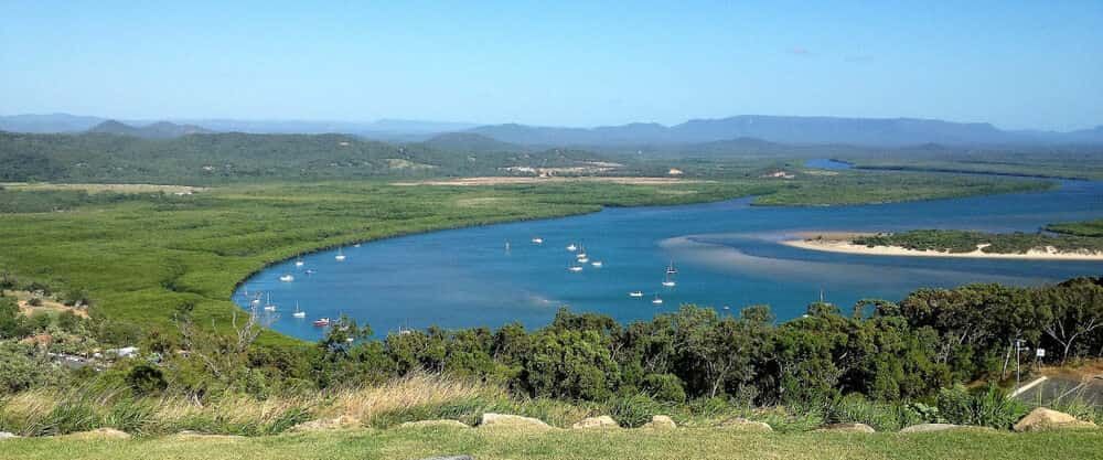 A River With Boats In It And Mountains In The Background — Allpower Electrical Wholesalers Pty Ltd In Cooktown, QLD