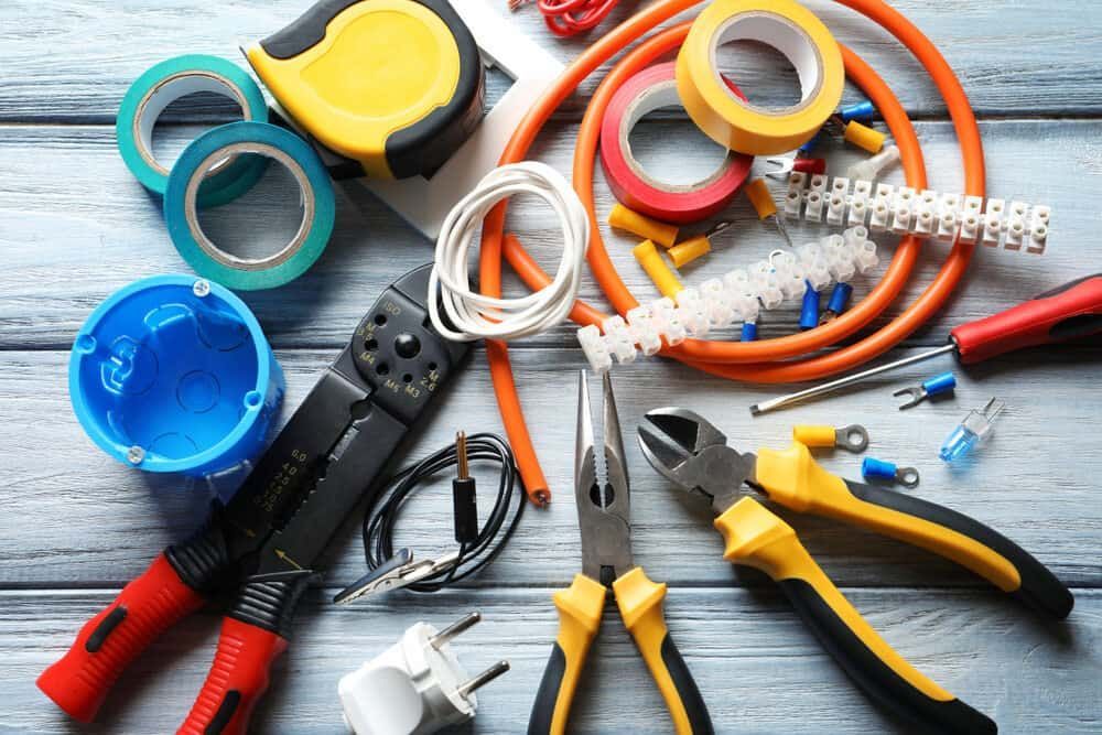A Bunch Of Electrical Tools Are Sitting On A Wooden Table — Allpower Electrical Wholesalers Pty Ltd In Bungalow, QLD