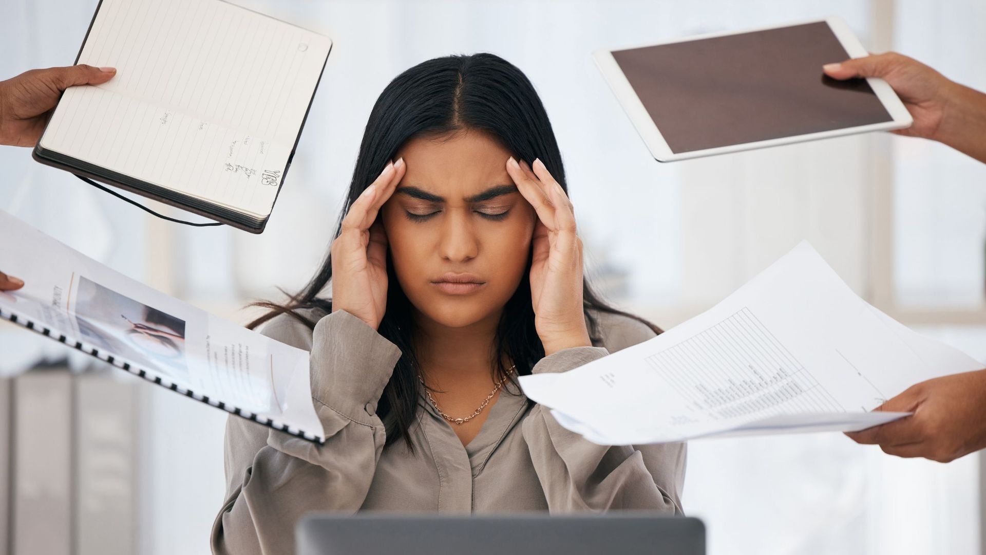 Person feeling overwhelmed at work