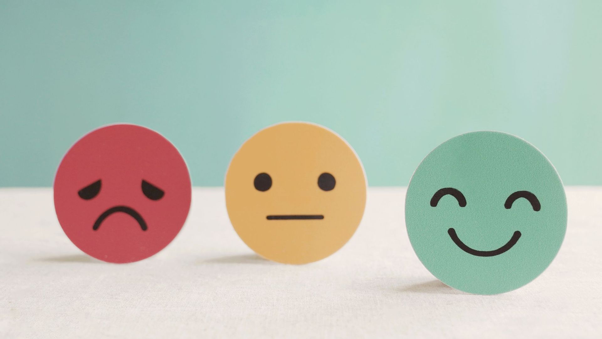 Red, yellow and green emoji faces depicting emotions