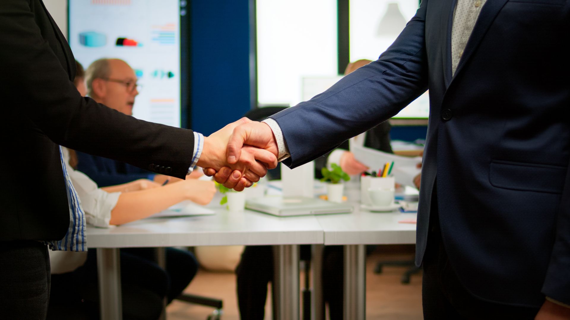 Business partners shaking hands, symbolizing successful B2B collaborations and our strategic ground assistance partnerships.