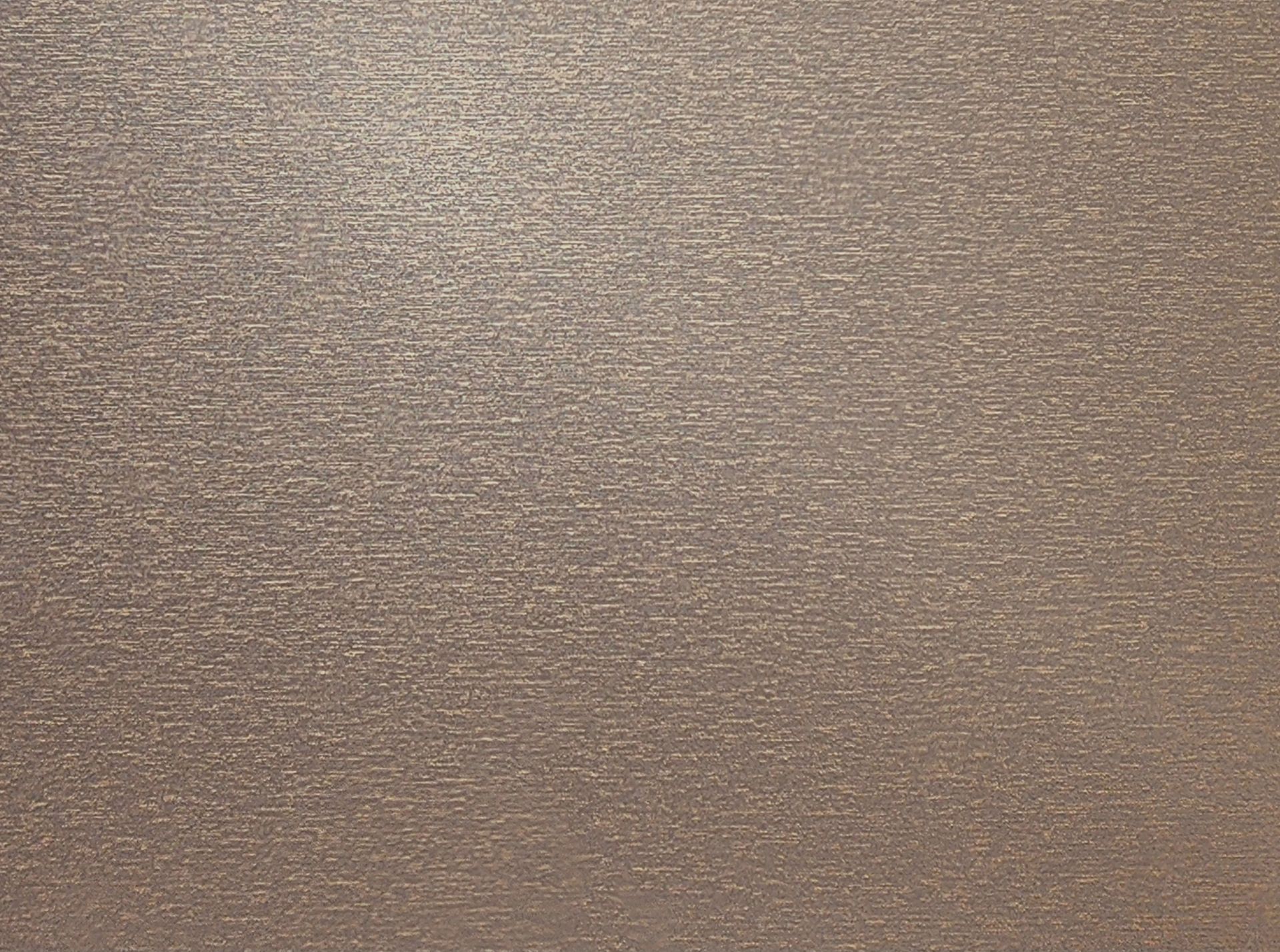 Close-up of a beige textured fabric or wall surface with subtle horizontal striations.