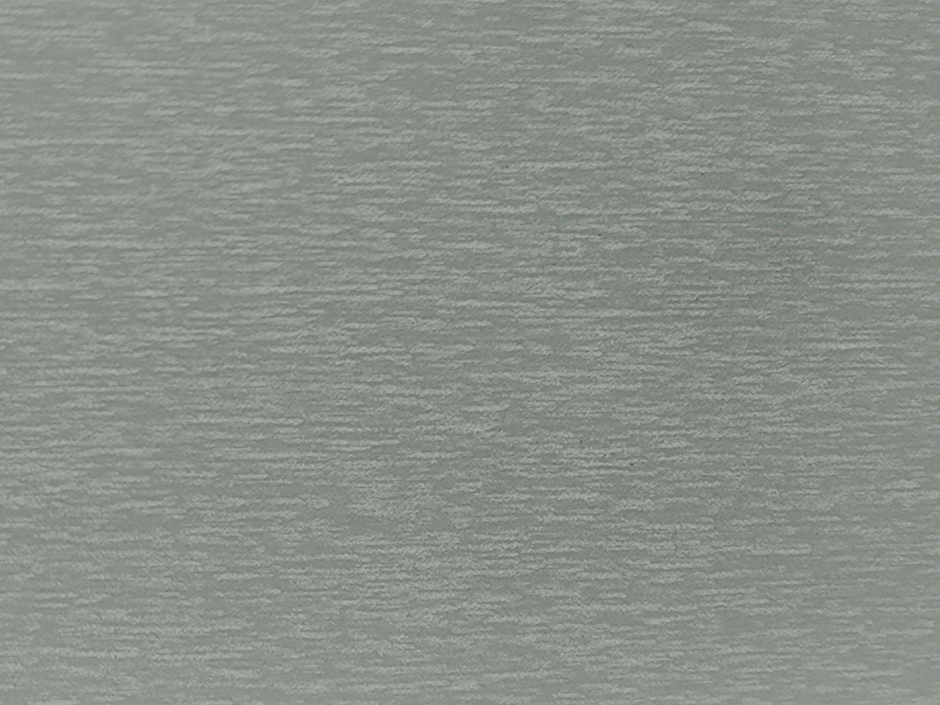 Close-up of a light gray textured surface with subtle horizontal patterning.
